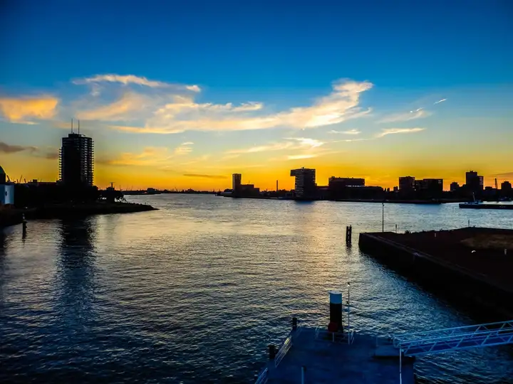 SS Rotterdam cruise ship hotel - Rotterdam skyline (sunset)
