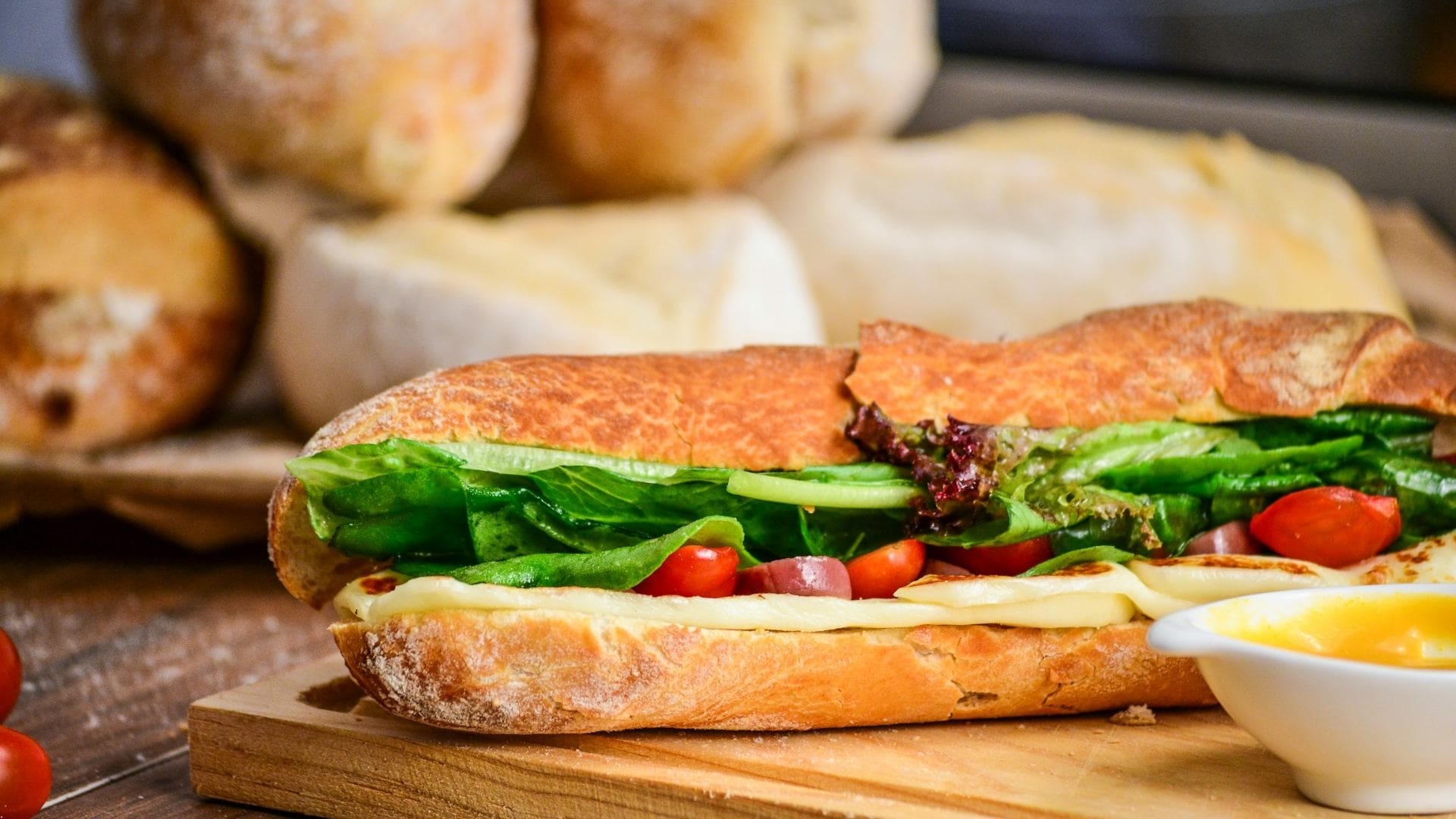 Tasty baguette with cheese and veggies