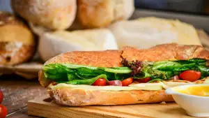Tasty baguette with cheese and veggies