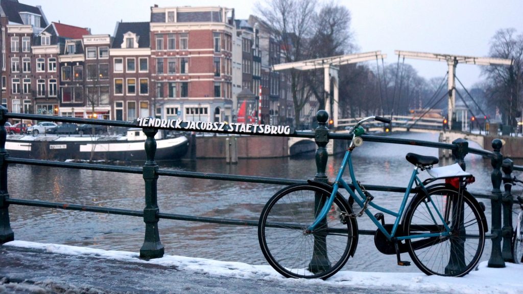 Bike on a bridge over a canal in Amsterdam - winter scenery
