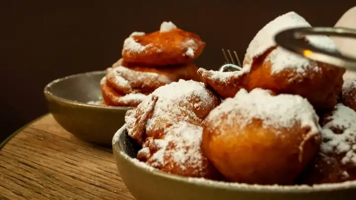 Close-up of a bowl of oliebollen - Dutch doughnuts