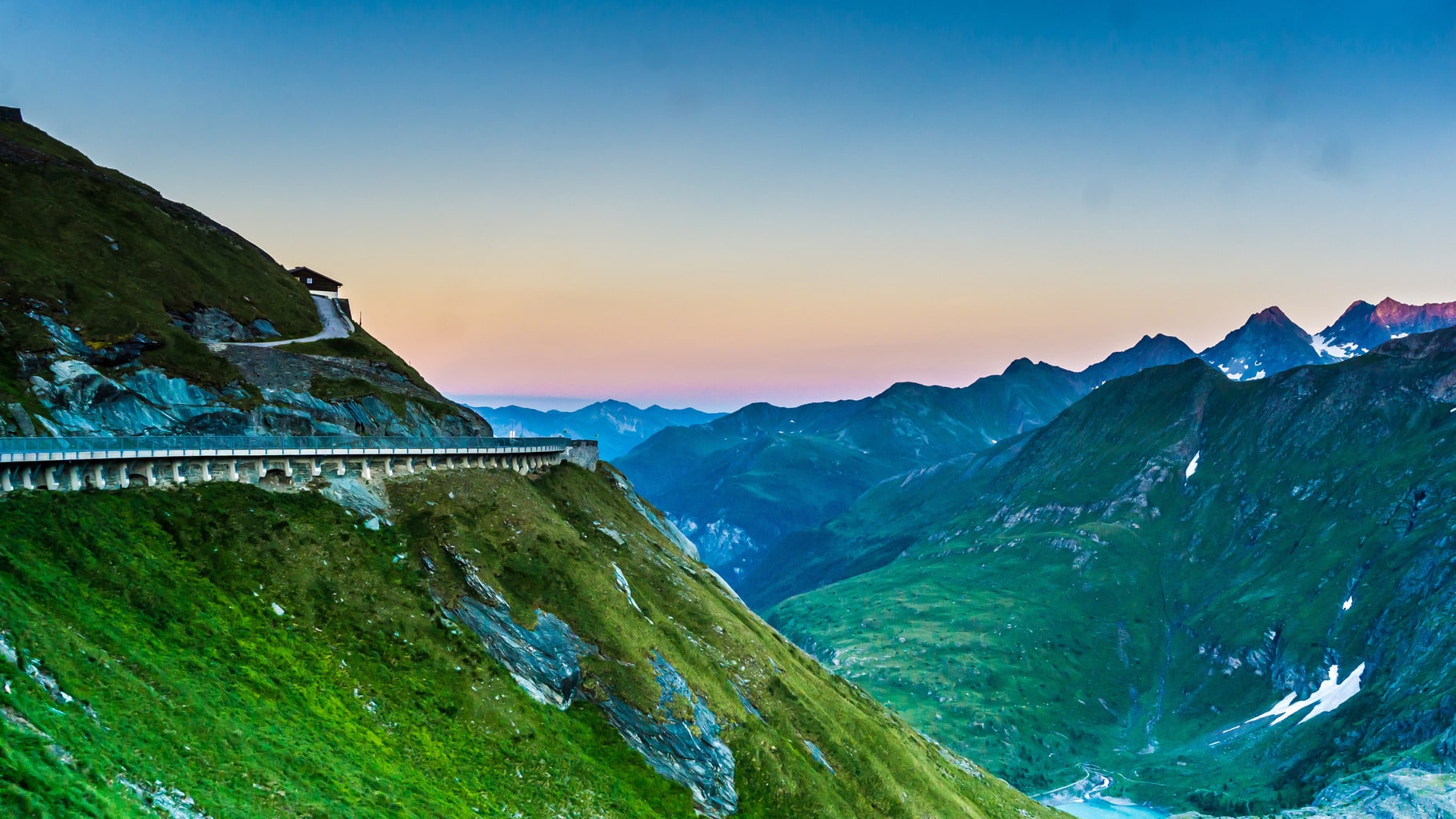 Road on mountain, from a distance. The sun is setting
