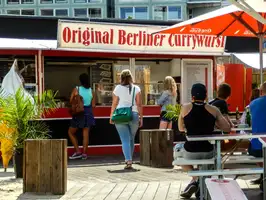 People ordering original Berlin Currywurst from a stall / food truck