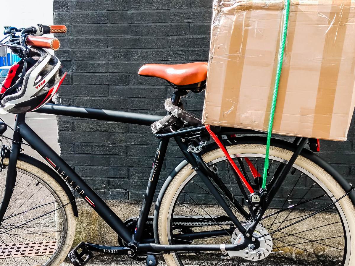 Close-up of a Dutch bike with a big parcel on the rack at the back