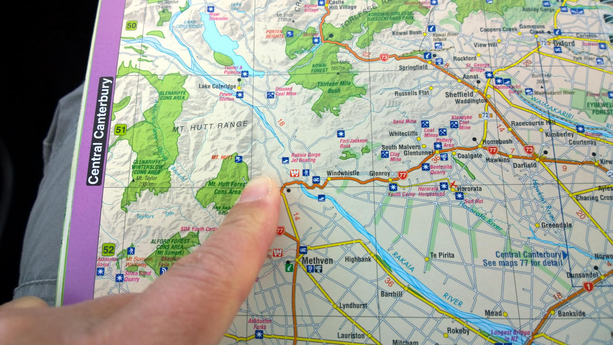 Map of New Zealand (central Canterbury) with a finger point at a location on the map