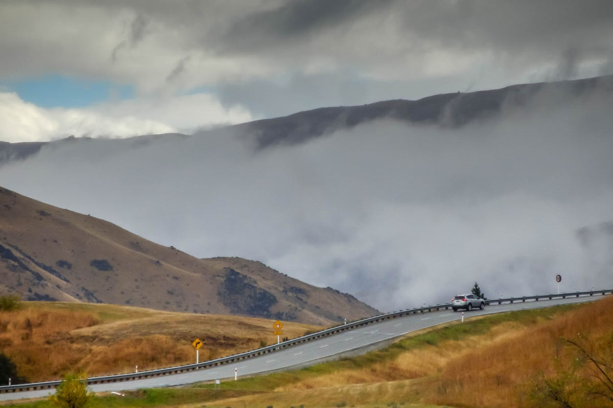 View over road and scenery in New Zealand - autumn weather, cloudy day