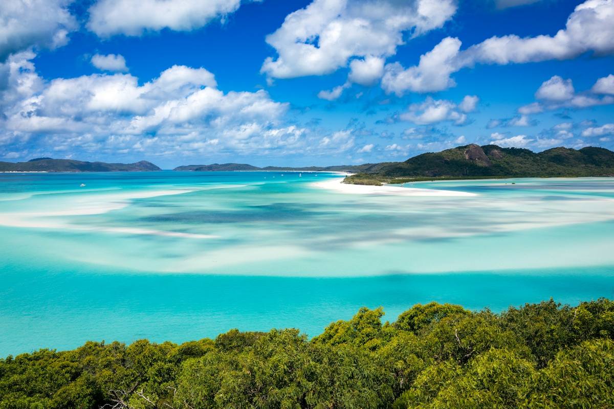 Blue water, blue sky and various islands dotted in the ocean