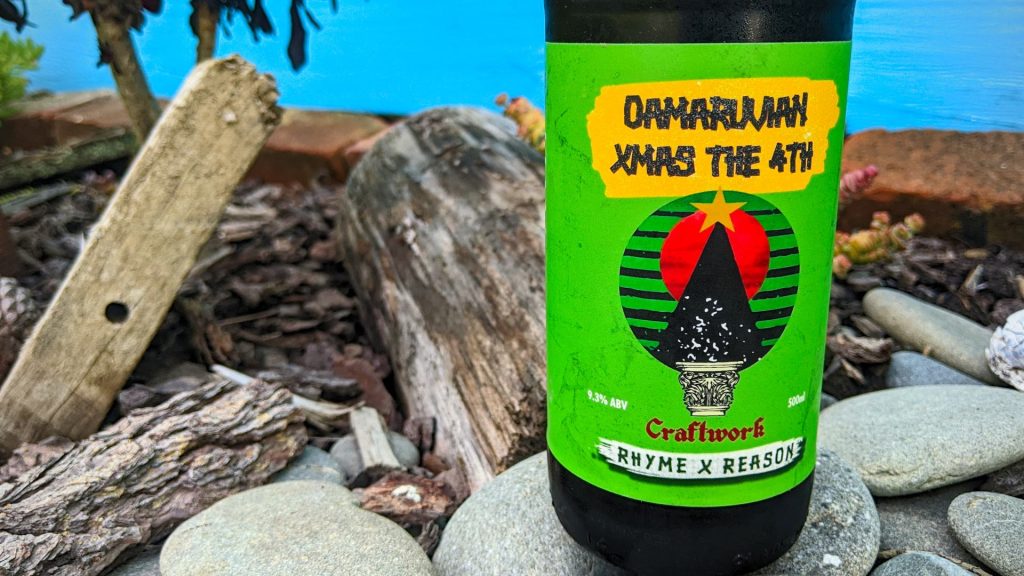 Bottle of Rhyme & Reason's Oamaruvian Christmas the 4th in a garden-like setting